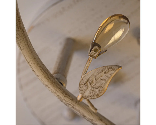 Prim-plan cu o lampă cu design floral, cu frunză și element din sticlă