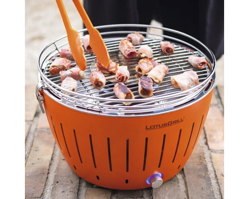 Grătar LotusGrill cu cârnați în bacon și clești pentru grătar