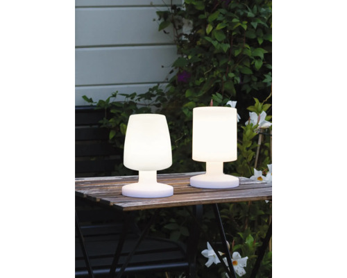 Două lămpi de masă cu LED fără fir pentru exterior pe o masă de grădină