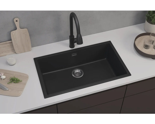 Chiuvetă neagră cu robinet pe un blat de bucătărie.