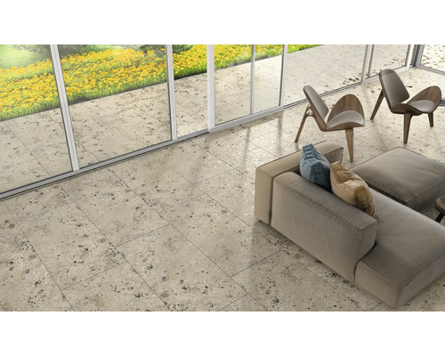 Cameră luminoasă cu gresie cu aspect de piatră, mobilier de ședere și fațadă de ferestre