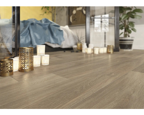 Fotografie de interior a unei camere cu podea de lemn deschisă la culoare, lumânări și decorațiuni