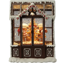 Casă decorativă din turtă dulce cu oameni de turtă dulce și zăpadă ca decorațiune de Crăciun