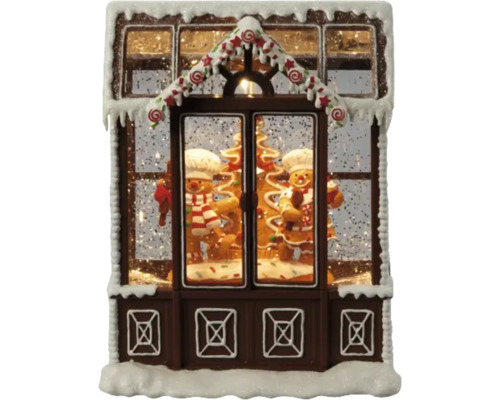 Casă decorativă din turtă dulce cu oameni de turtă dulce și zăpadă ca decorațiune de Crăciun