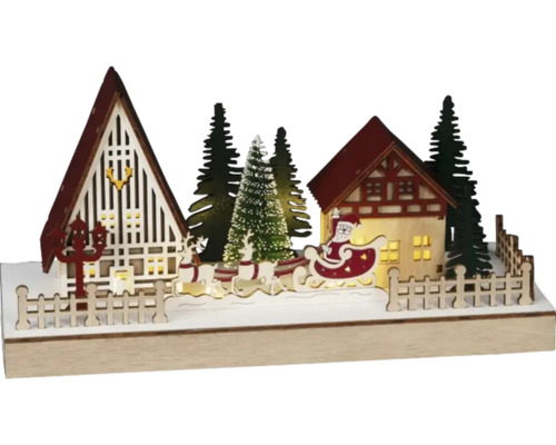 Peisaj decorativ de Crăciun cu case, brazi, reni și Moș Crăciun într-o sanie