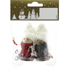 Două figurine decorative într-un ambalaj cu căciuli albe și haine din pâslă ca decorațiuni de Crăciun.