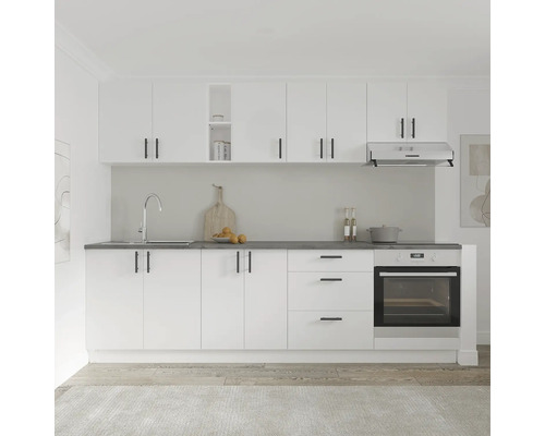 Bucătărie luminoasă cu dulapuri albe, blat de lucru întunecat și elemente din oțel inoxidabil.