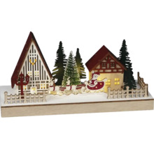 Decorațiune de Crăciun iluminată cu case, brazi și Moș Crăciun într-o sanie