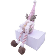 Figurină decorativă cu pitic cu căciulă, barbă și coarne pe un pachet