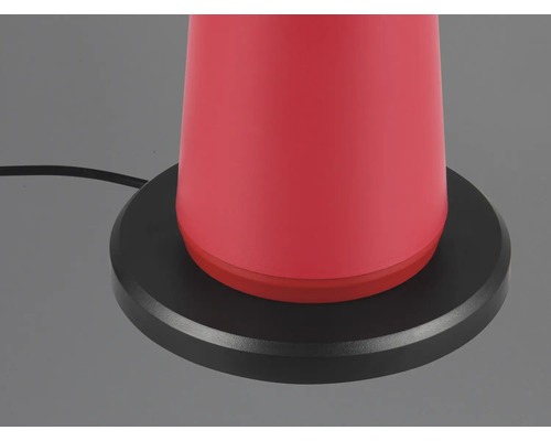 Prim-plan cu o lampă de masă roșie cu bază neagră