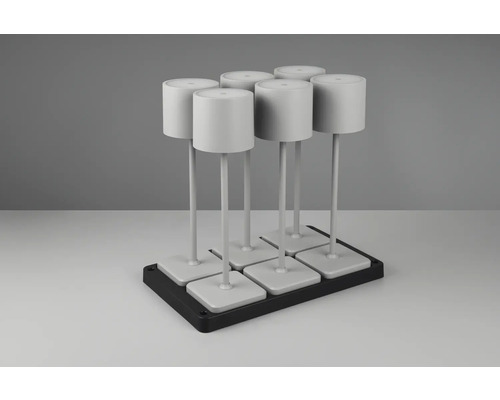 Șase lămpi albe pe o bază neagră.