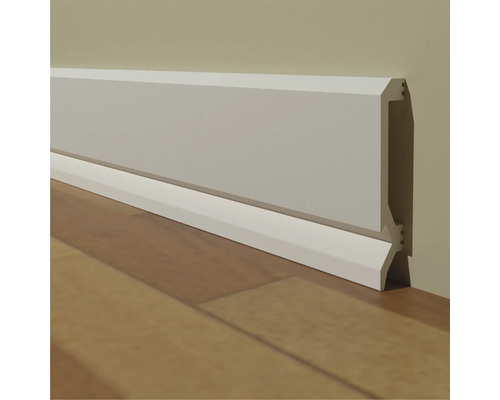 Plintă pe un perete pe o podea de lemn