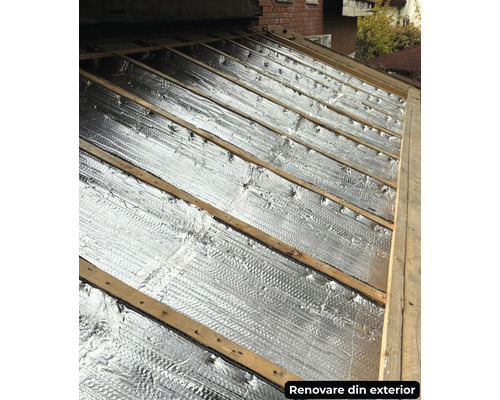 Izolație de acoperiș cu folie de aluminiu între grinzi de lemn