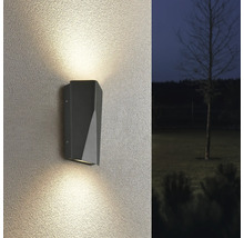 Lampa de perete gri cu con de lumină pe peretele casei