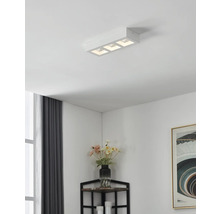 Lumină de plafon cu trei lămpi într-un living modern.