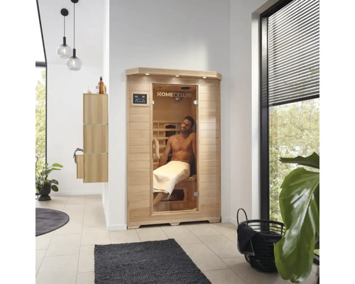 Fotografie de interior a unei băi cu o saună Home Deluxe și un bărbat cu un prosop