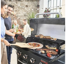 Oameni care fac grătar pizza, carne și legume pe un grătar negru pe gaz, în aer liber.