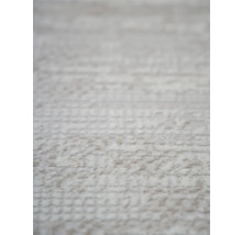 Prim-plan cu un covor deschis la culoare cu textură