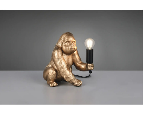 Lampă de masă decorativă în formă de gorilă aurie care ține un bec