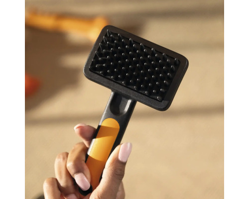 Perie de câine cu peri în mână