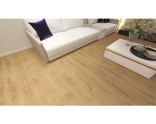 Living luminos cu pardoseală laminată cu aspect de stejar, o canapea albă cu pernă mov și o măsuță de cafea albă cu flori.