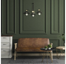 Cameră de zi cu canapea, comodă, masă și lampă suspendată în fața unui perete cu panouri.