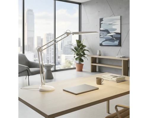 Birou luminos cu birou, lampă de birou, laptop, plantă și fereastră cu vedere la oraș