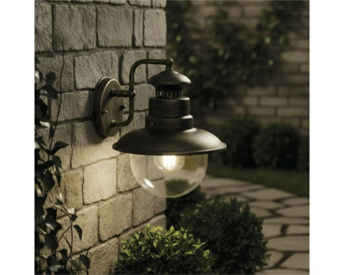 Lampa de perete pentru exterior cu glob de sticlă pe un zid de piatră