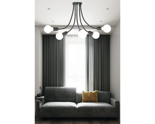 Living modern cu lampă suspendată neagră, canapea gri și perdele.