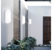 Exterior cu trei lumini de perete albe pe un perete