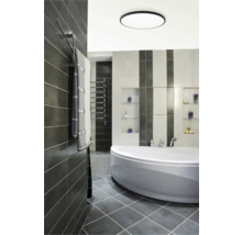 Baie modernă cu cadă, radiator pentru prosoape și gresie gri