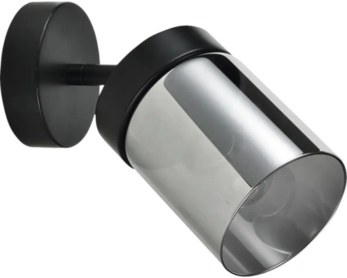Spot de perete modern cu bază metalică neagră și abajur cilindric din sticlă fumurie.