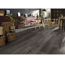 Pardoseală laminată aspect lemn închis într-o încăpere modernă cu masă din lemn și lăzi de vin.