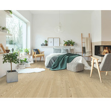 Dormitor luminos cu pardoseală laminată cu aspect de lemn deschis, cu pat, fotolii, plante de interior și un șemineu primitor.