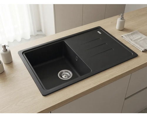 Chiuvetă încorporată neagră cu picurător pe un blat din lemn deschis, într-o bucătărie luminoasă cu design modern.