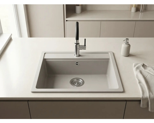 Chiuvetă încorporabilă într-un blat de bucătărie deschis la culoare cu o baterie modernă din crom și negru și un dozator de săpun.