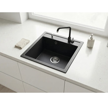 Chiuvetă de bucătărie modernă, pătrată, din compozit negru, cu baterie, încorporată într-un blat deschis la culoare într-o bucătărie luminoasă.