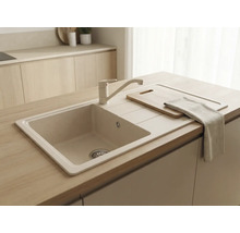 Chiuvetă încorporabilă bej cu baterie asortată într-o bucătărie din lemn deschis. Include picurător, tocător și prosop de bucătărie.