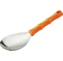 Lopățică pentru transplantat din oțel inoxidabil cu margini zimțate și mâner din plastic portocaliu.