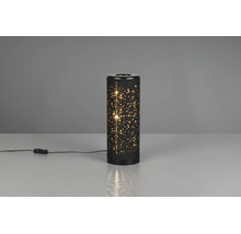 Veioză cilindrică din metal negru cu decor în formă de stele prin perforații și întrerupător pe fir, aprinsă.