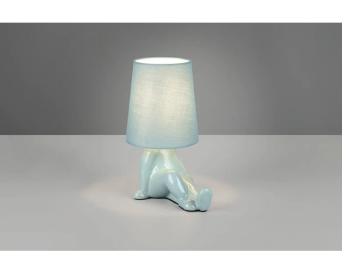 Veioză albastră cu bază din ceramică în formă de figură așezată și abajur din material textil.