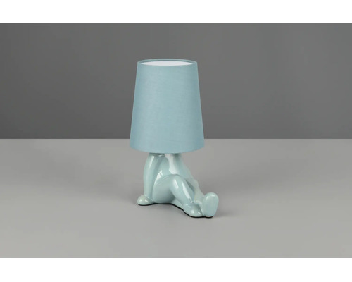 Lampă de masă albastru deschis cu bază sub formă de figură șezândă din ceramică și abajur din material textil