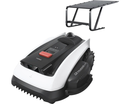 Robot de tuns gazonul cu garaj în negru și alb, cu buton de oprire roșu și anvelope de teren.