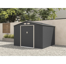 Șopron de grădină modern din metal antracit cu acoperiș în două pante și ușă dublă, amplasat pe un pavaj în fața unui zid de grădină.