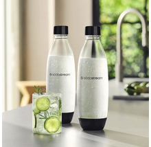 Două sticle din plastic SodaStream cu capac și bază negre lângă un pahar cu apă cu lămâie verde într-o bucătărie luminoasă.