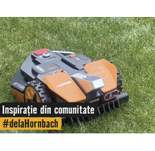 Robot de tuns iarba Worx Landroid Vision în funcțiune pe un gazon îngrijit.