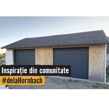 Garaj dublu în construcție cu pereți din plăci OSB, două uși secționale antracit și acoperiș din șindrilă bitumoasă.