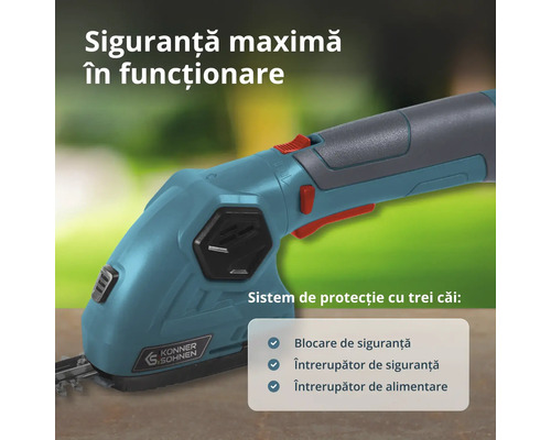 Detaliu al mânerului foarfecei pentru gard viu Konner und Sohnen cu sistem de protecție cu trei căi și comutatoare de siguranță.