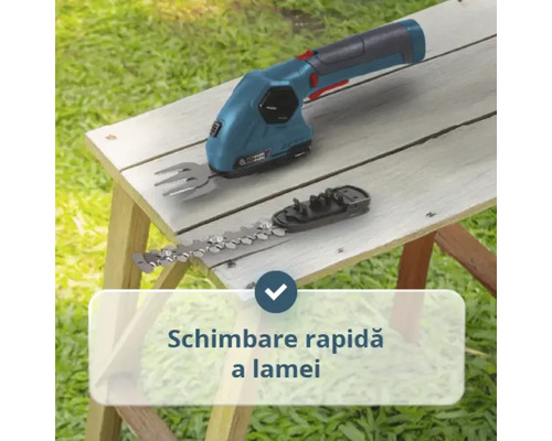 Foarfecă pentru iarbă cu acumulator și lamă interschimbabilă pentru arbuști pentru schimbarea rapidă a lamei pe o masă de lemn.