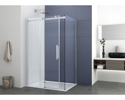 Cabină de duș pe colț cu ușă glisantă într-o baie cu dulap de lavoar și prosop